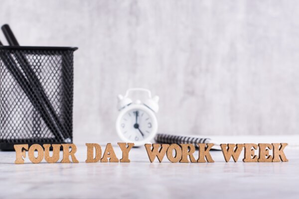 four-day-work-week-word-from-wooden-letters-on-desktop