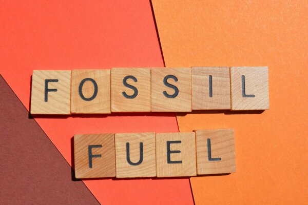 fossil-fuel-words-in-wooden-alphabet-letters-isolated-on-red-background