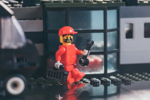 kyiv-ukraine-march-15-2019-red-lego-worker-figurine-in-hat-holding-wrench-and-tool-box-near
