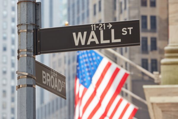 wall-street-sign-near-stock-exchange-with-us-flags-new-york