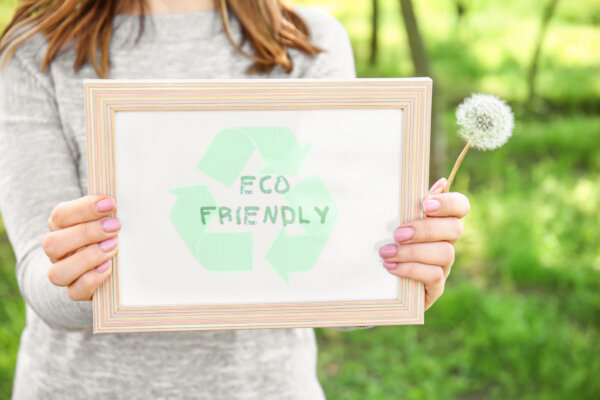 young-woman-holding-board-with-text-eco-friendly-o-2025-10-15-21-22-44-utc-2048×1365-1