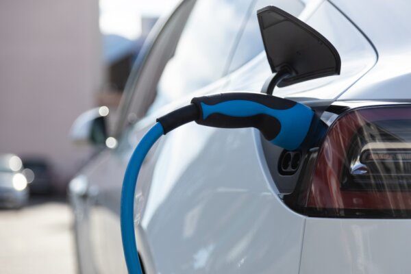 ev-electric-car-pluged-charging-at-a-recharge-station-in-the-city