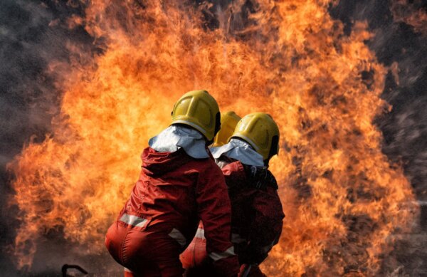 fire-fighter-team-on-training-with-gas-and-oil-fire-hold-hose-spray-jet-water-spray-to-extinguish