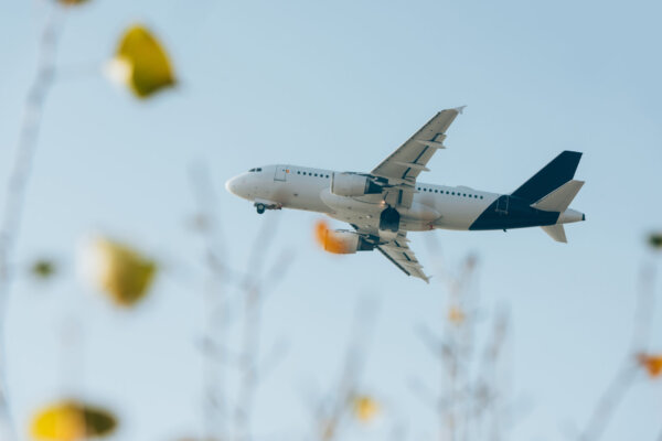 selective-focus-of-airplane-in-blue-sky-above-fiel-2026-03-11-03-22-33-utc-2048×1367-1
